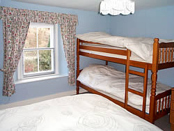 Farmhouse bedroom with bunk beds and double bed